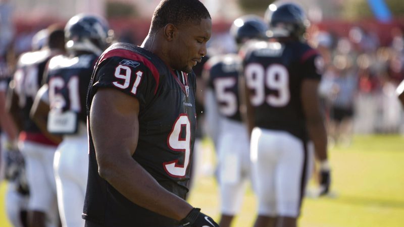 Football players walking off the field at training camp
