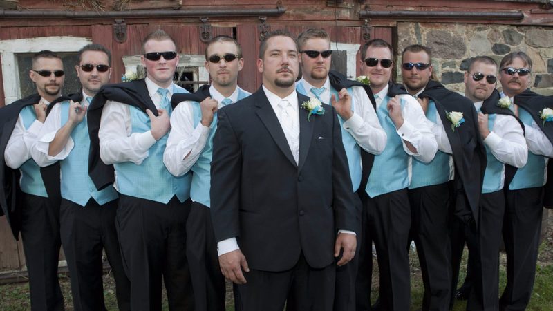 Groom and groomsmen in sunglasses and turquoise vests